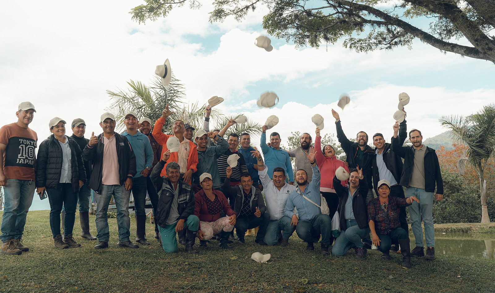 The Cirkular Origin team and growers of the program together in the field, throwing their hats in the air