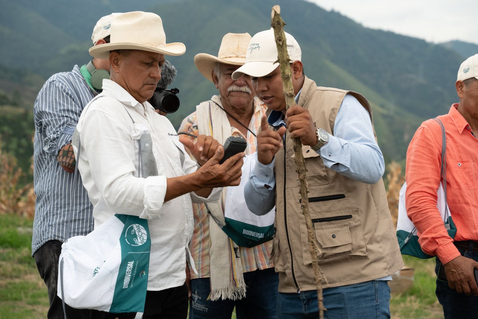The field team and growers checking records on their phones