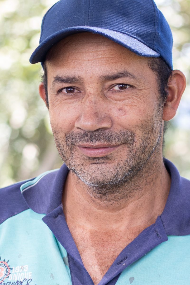 A coffee grower in the program among the trees of his farm